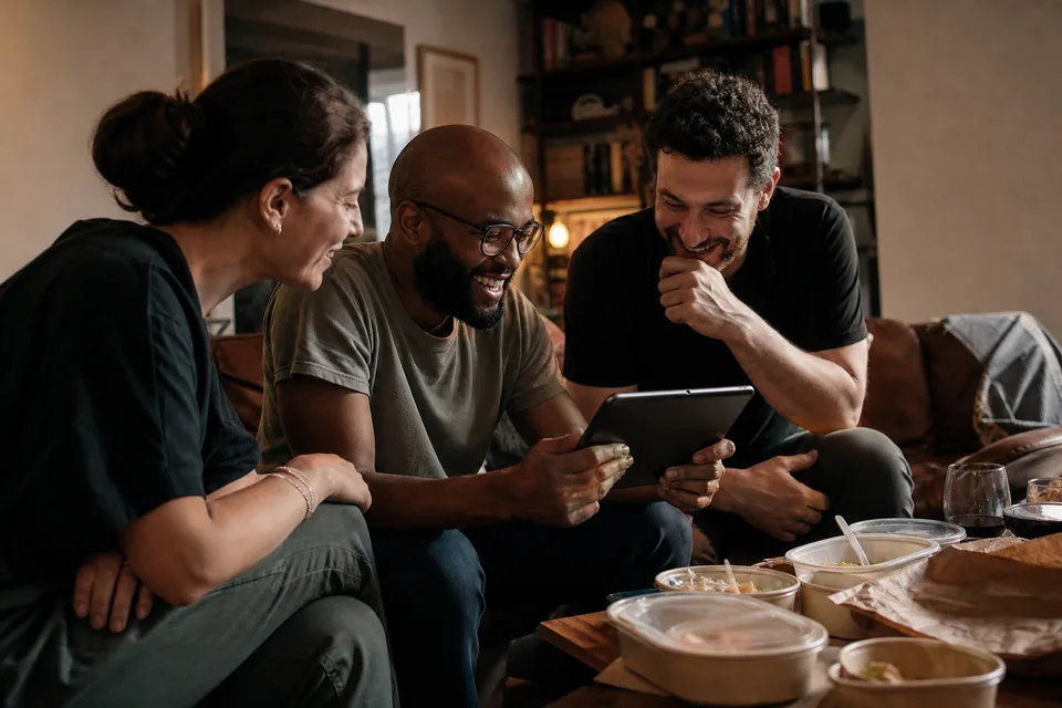 Friends on a sofa watching a creator's new cooking video together